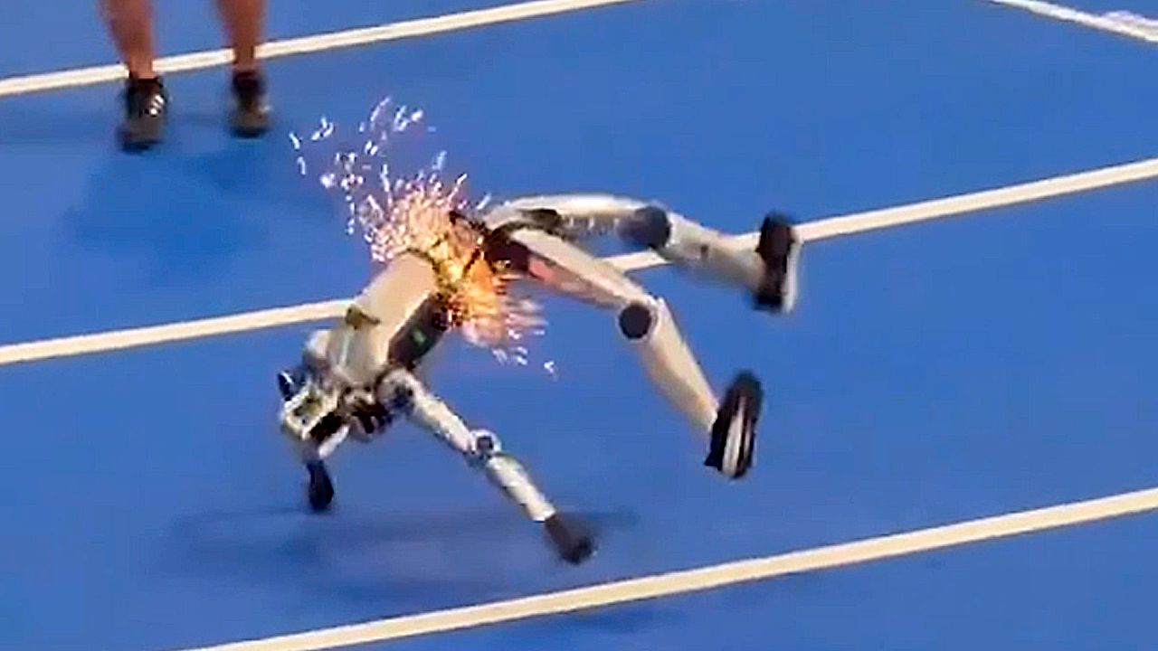 Humanoid robot slams into barrier and falls in shower of sparks during ...