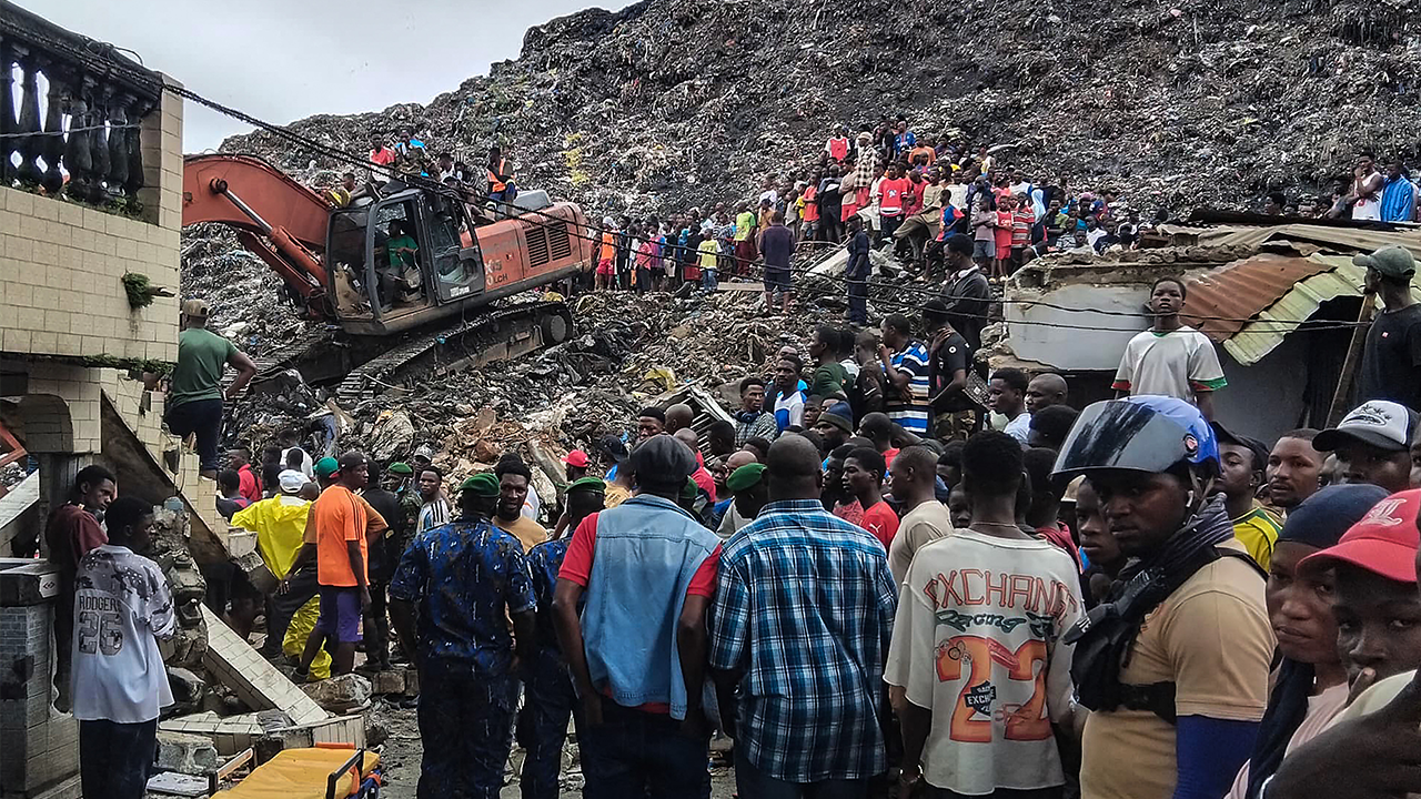 Residents and rescuers use an excavator to search for victims after a landslide struck the Dar Es Salam dumpsite in Conakry, Guinea, on Aug. 23, 2026. Getty Images