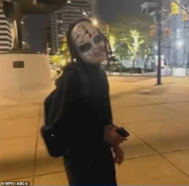 The suspect, seen with a phone in his hand, allegedly terrorized multiple people in the community