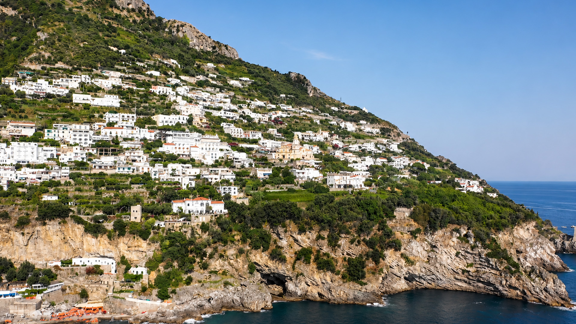 Roads and homes climb this massive coastal slope