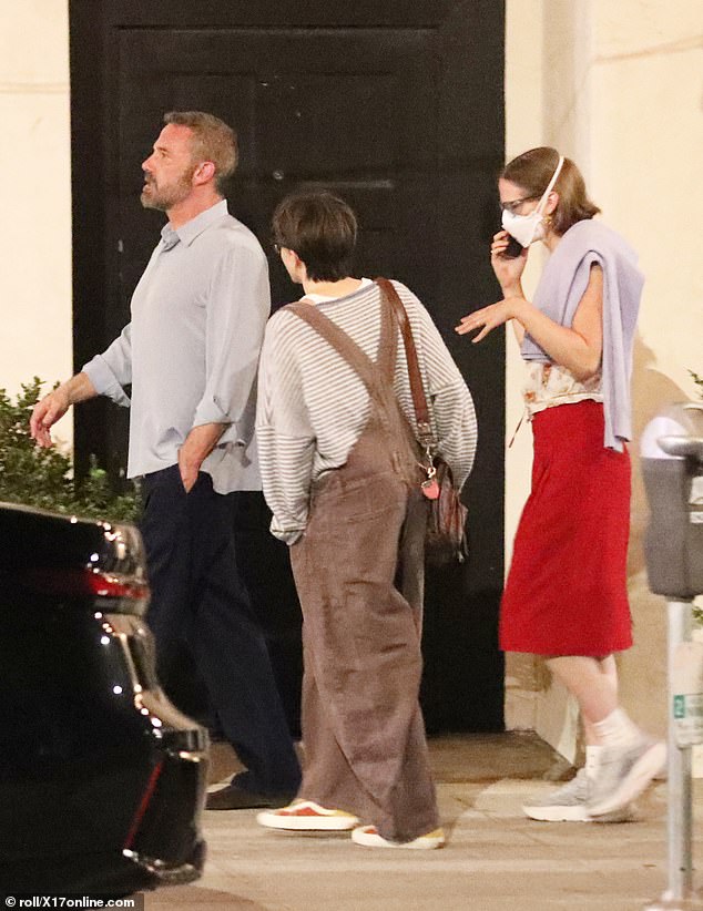 Fin was clad in a striped sweater, dark overalls, and sneakers for the family outing
