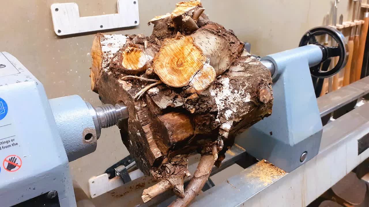 This sycamore root was a tangled mess - then he mounted it on the lathe