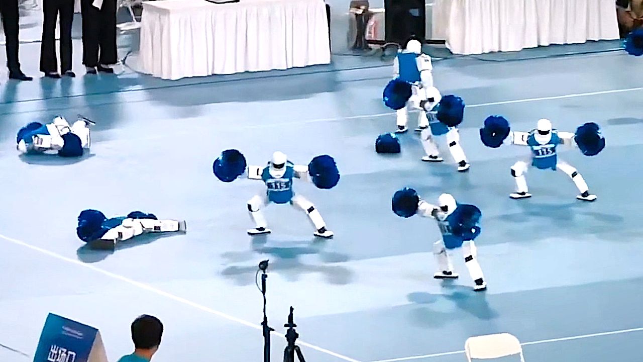 Robots with pom-poms tumble during cheerleading routine at World Robot ...