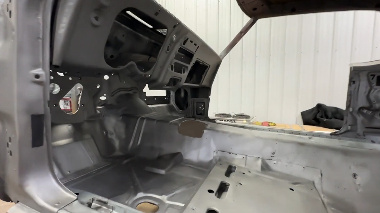 Inspecting a Camaro shell before restoration