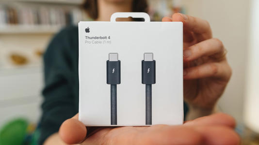 Person holding the box for Thunderbolt 4 cables