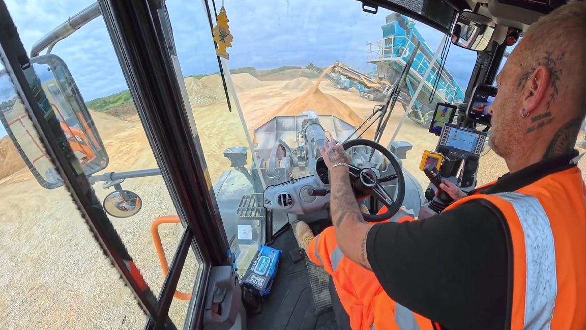 Heavy equipment operator takes on a massive material pile