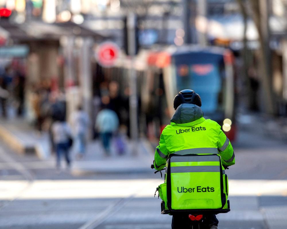 Delivery drivers will get a minimum wage in Australia's ‘world-first' deal. But is it fair – and will your Uber Eats cost more?