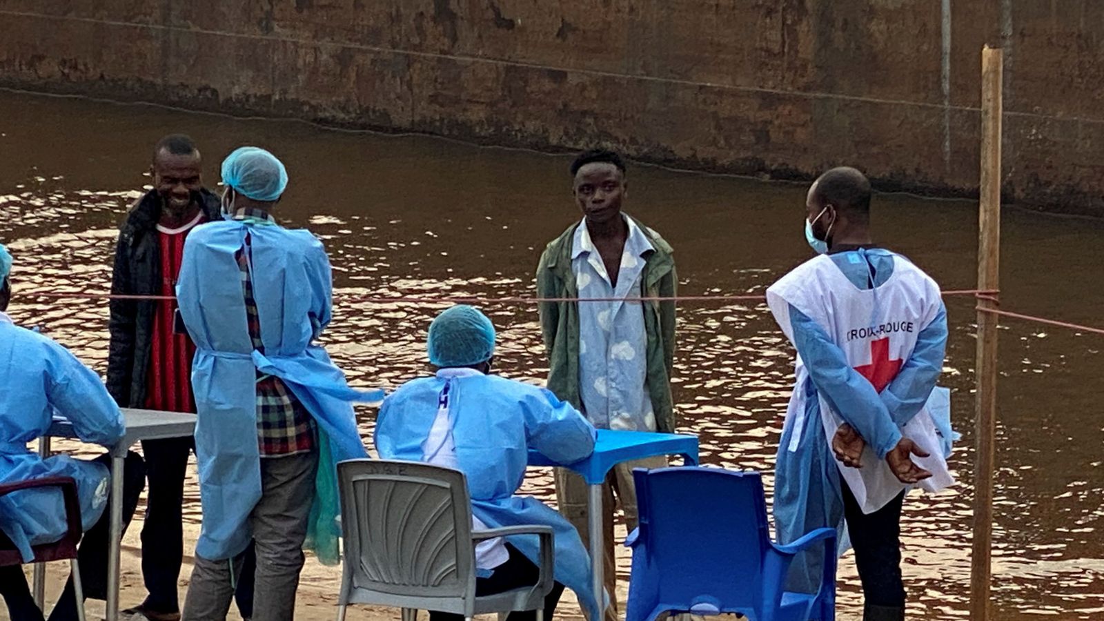 Passengers from a boat intercepted by health authorities wait to be tested for Ebola in Kinshasa. Pic: Reuters