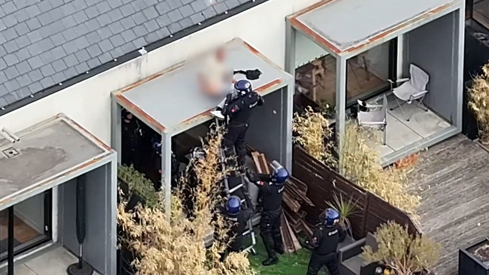 Police pull sleeping man off roof after two-day stand-off