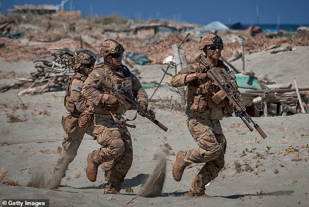 The prize, which will be handed to individuals by the Islamic Republic of Iran’s Army, will be doubled for 'courageous Iranian women,' Hatami stated. (Pictured: US troops take part in a counter-landing live fire exercise in the Philippines as tensions rise with the US and Iran)