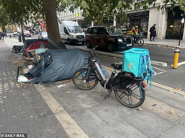 Tents and bike on Tottenham Court Road