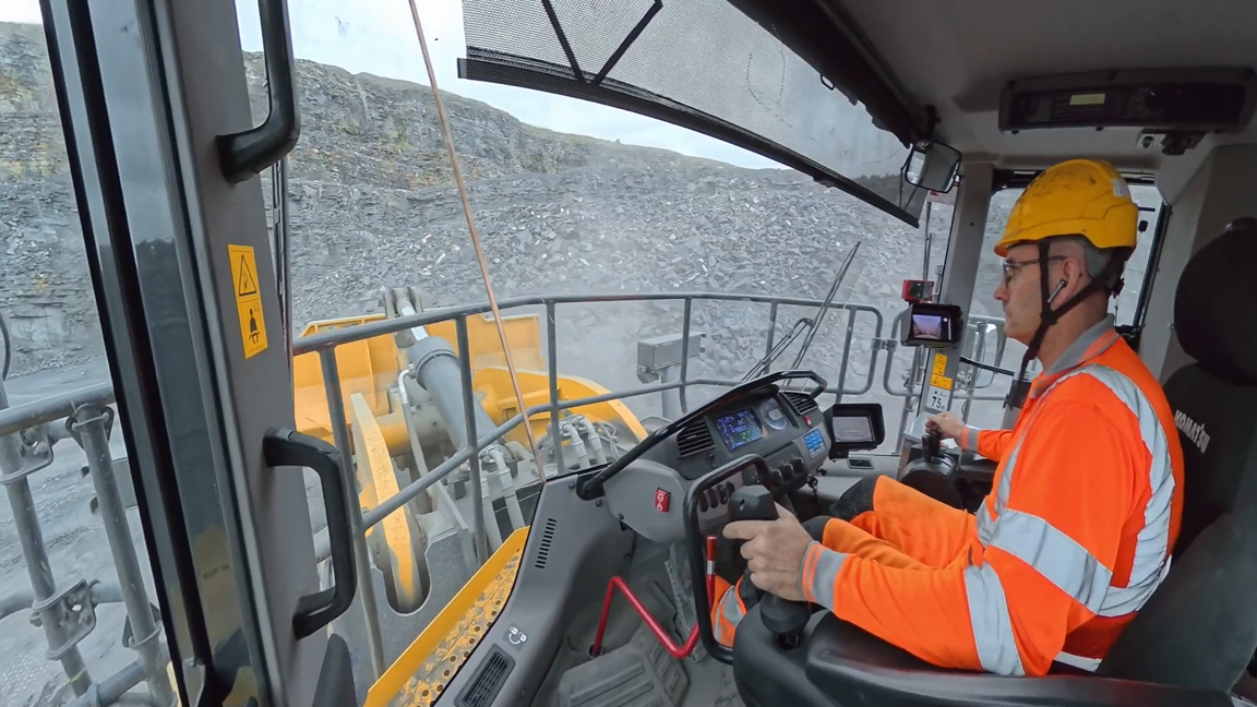 Skilled heavy equipment operator controls a massive loader