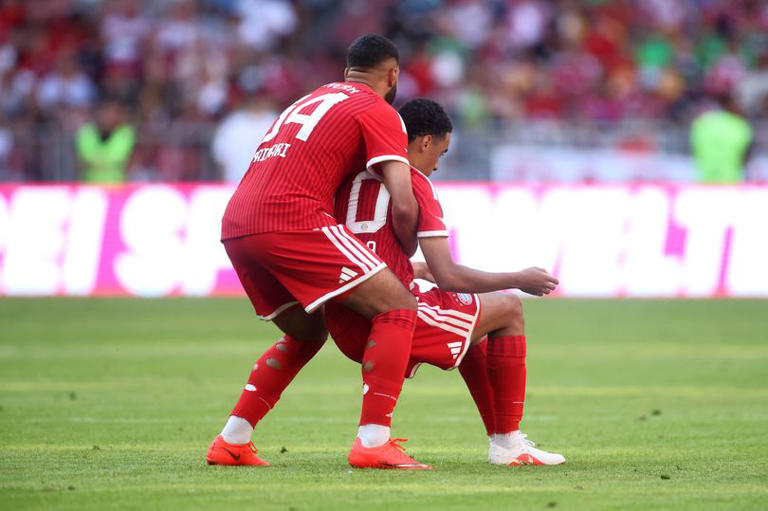 MUNICH, GERMANY - AUGUST 15: Ismael Saibari of Bayern Munich helps teammate Jamal Musiala who appears injured before going to ground during the Telekom Cup match between FC Bayern München and RB Leipzig at Allianz Arena on August 15, 2026 in Munich, Germany. (Photo by Alex Grimm/Getty Images)