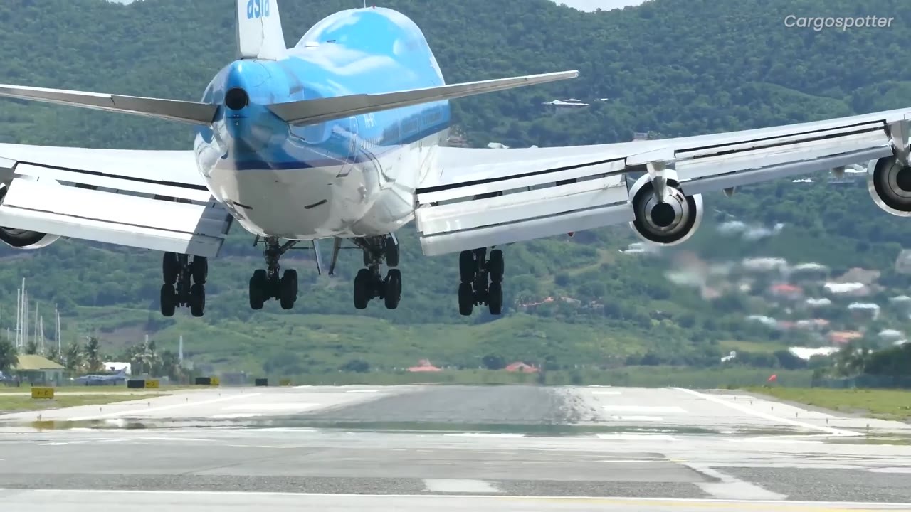 Watch airliners thread between giant mountains at one of the world's ...