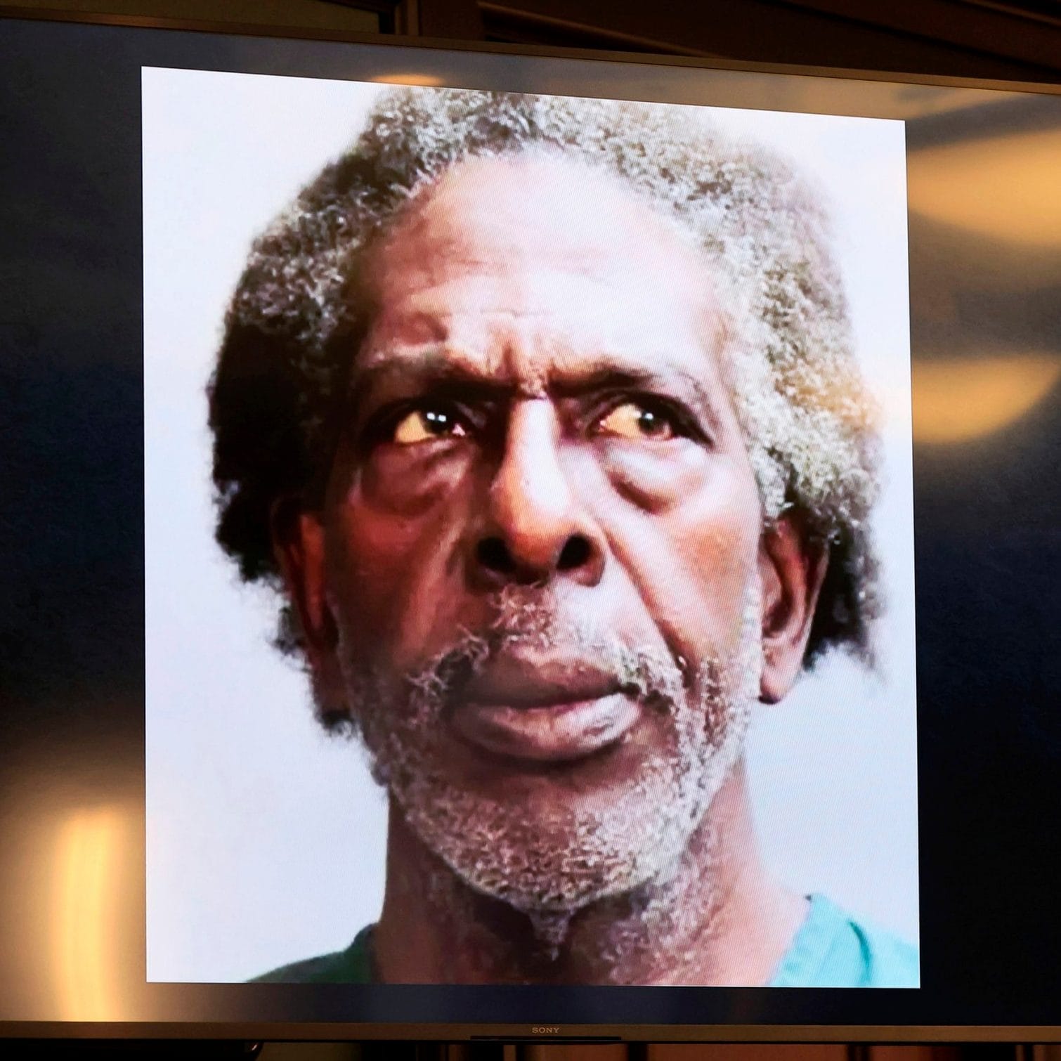 A photo of Henry Tenon is shown in court - Corey Perrine