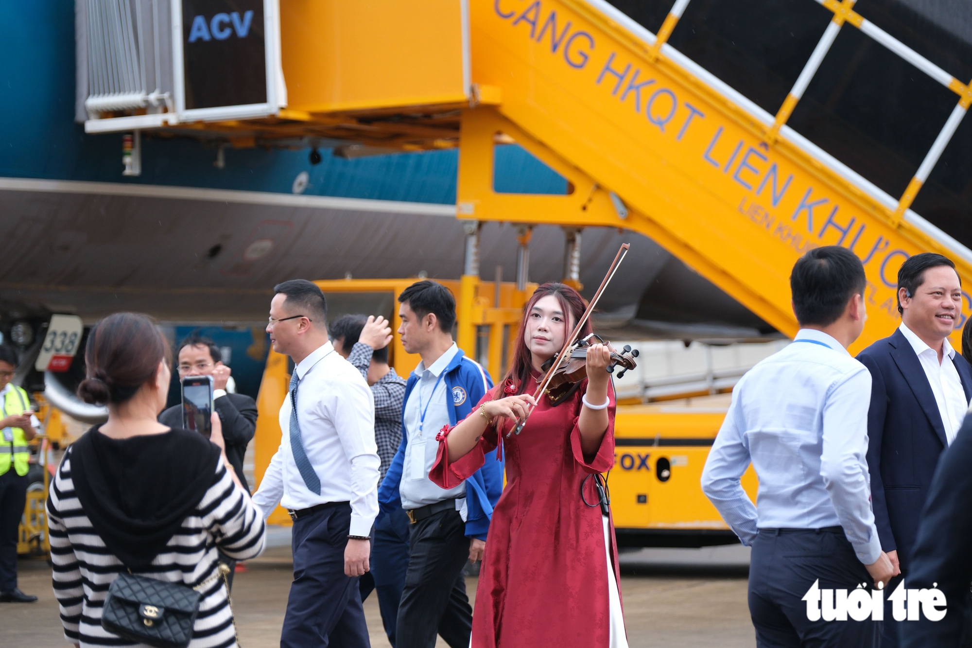 Khi rời cầu thang máy bay, du khách được chào đón bằng màn biểu diễn đàn violine - Ảnh: M.V.