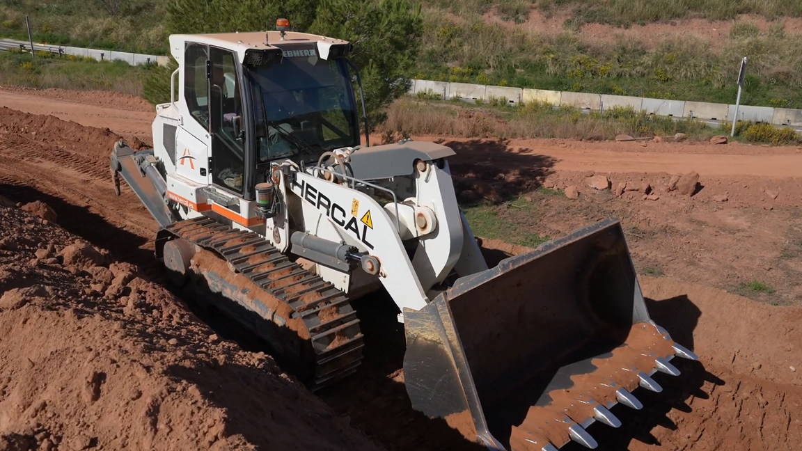 Powerful Liebherr crawler loader pushing through tough ground