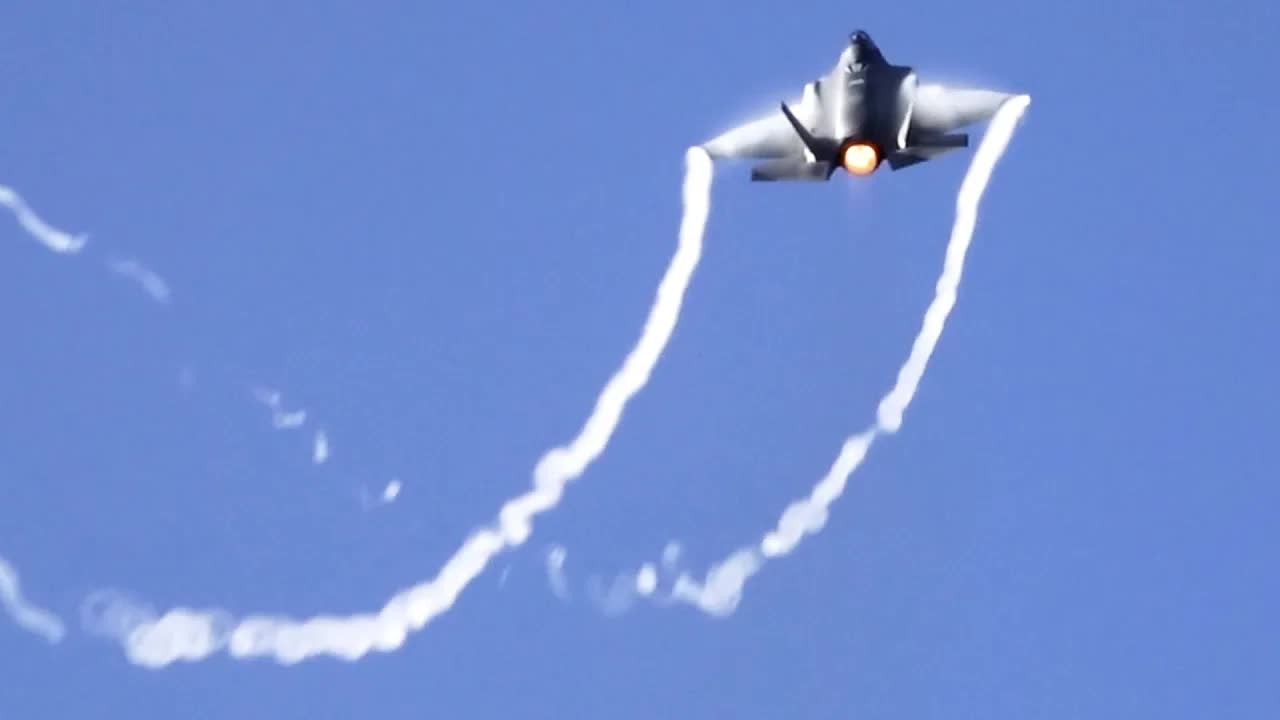 An F-15 and F-35 blast past low and pull into a quick climb - 