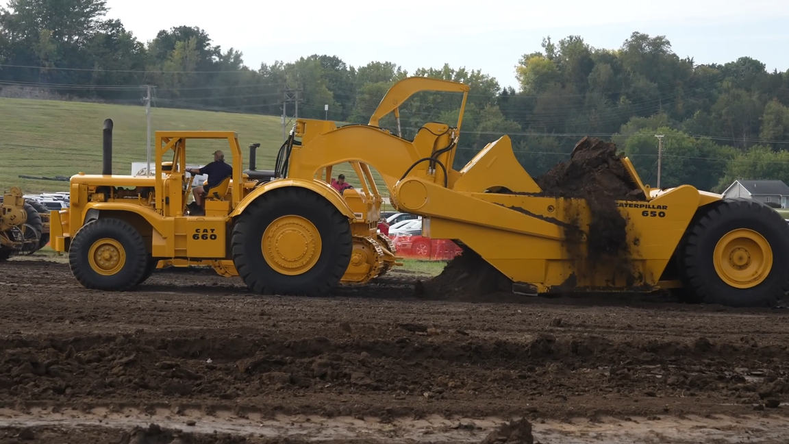Massive vintage CAT scraper loading dirt