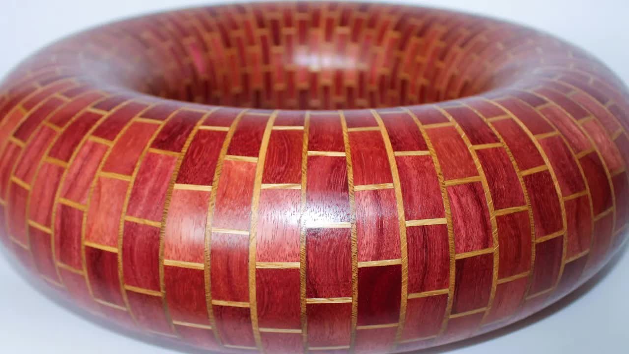 This wooden donut is built from dozens of tiny segments