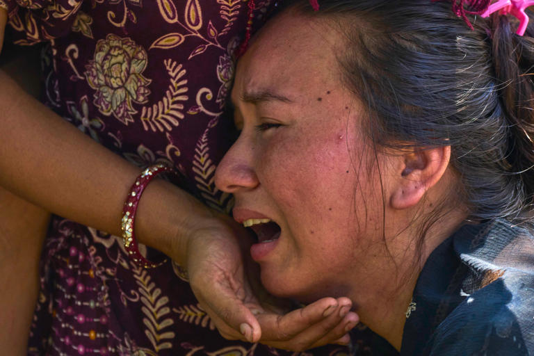 A girl cries as she waits for news of relatives missing after flash floods in Bidur, Nepal’s Nuwakot district (Niranjan Shrestha/AP) (AP)