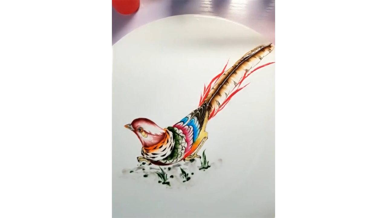 Drawing colorful pheasant with ink creating detailed wildlife illustration