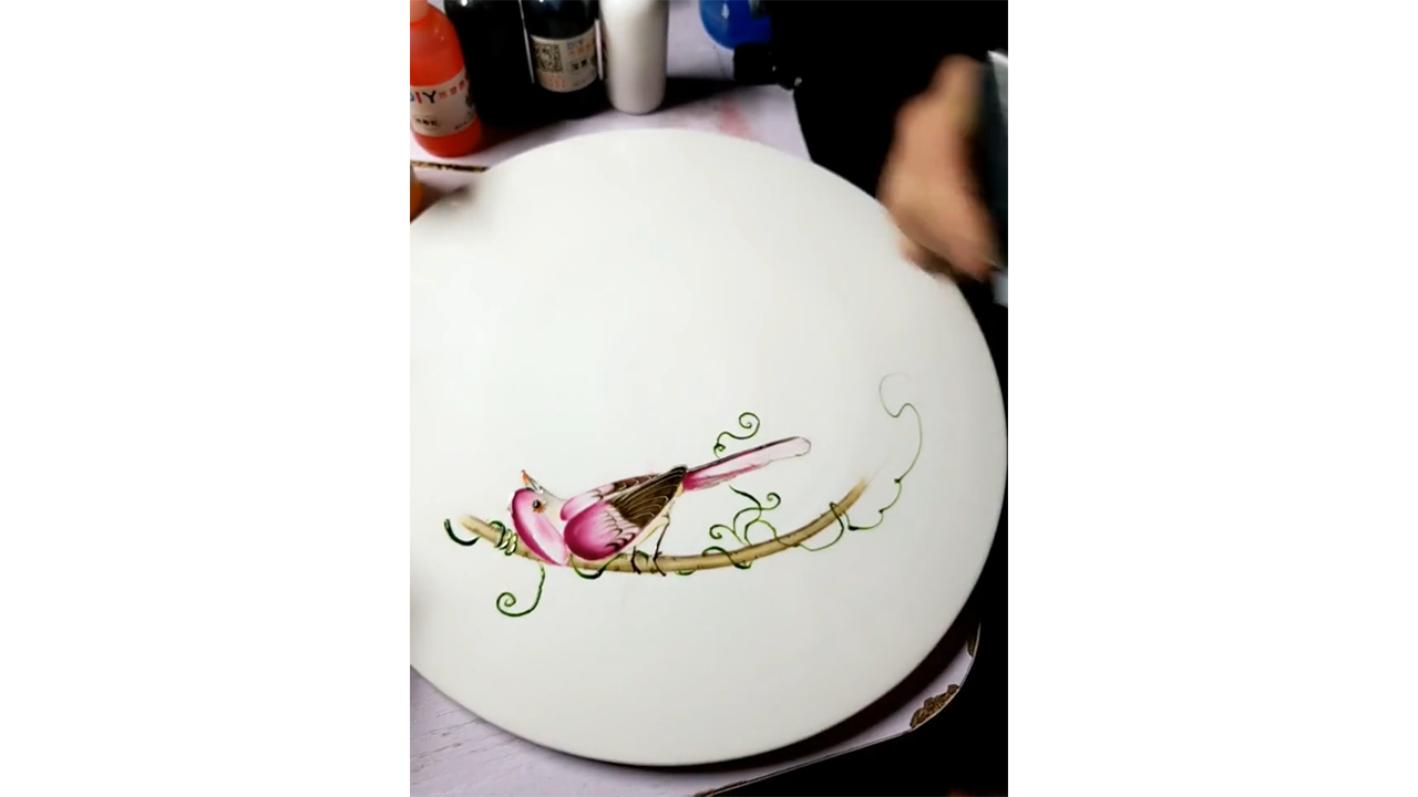 Drawing pink bird resting on branch with ink creating elegant nature ...