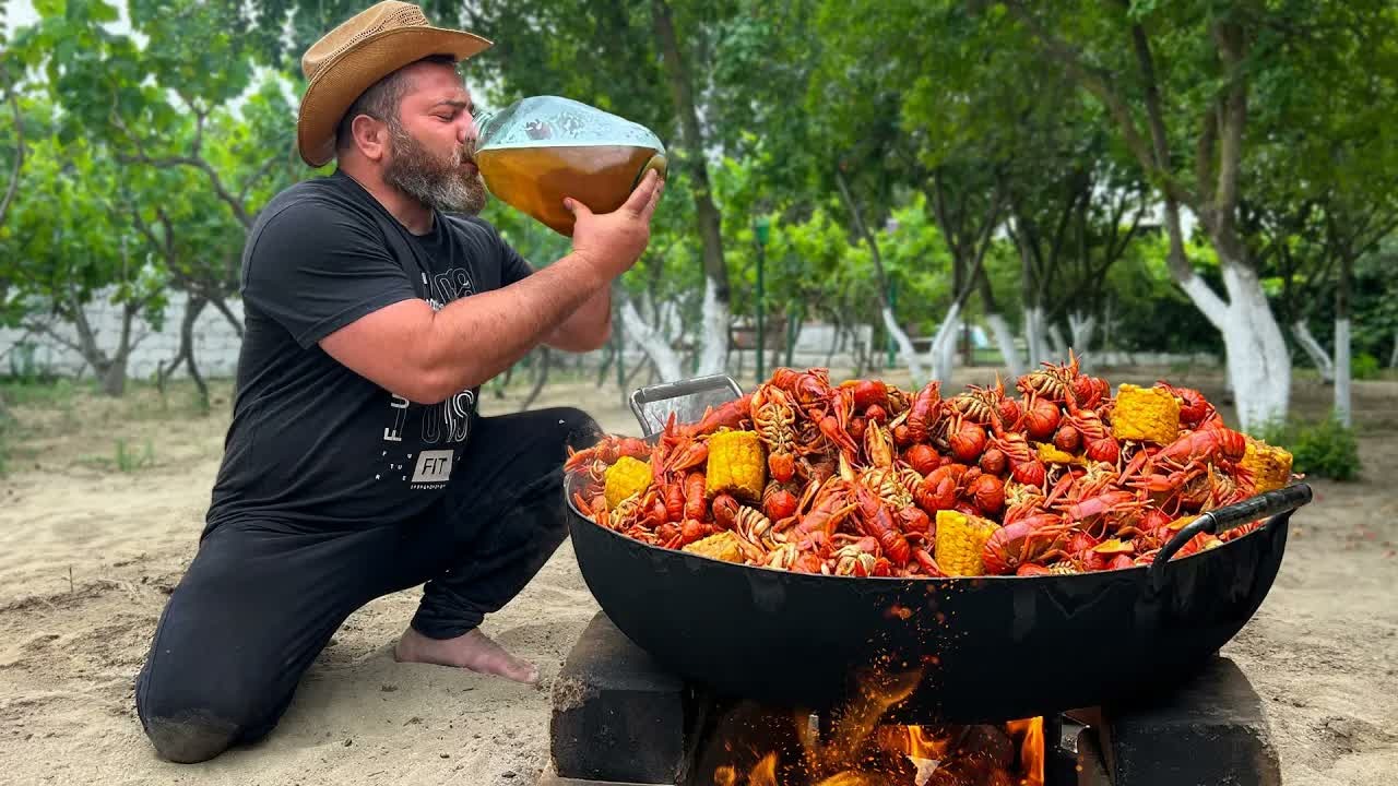 A giant cauldron of crayfish cooked over fire – the ultimate beer snack