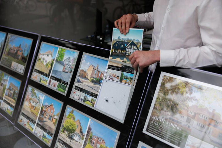 Properties listed for sale in an estate agent's window in Woking, UK, on Monday, June 1, 2026. UK house prices fell at the fastest pace for almost a year, according to one of Britain's biggest mortgage lenders, suggesting the surge in borrowing costs triggered by the Iran war is placing a strain on prospective homebuyers. Photographer: Jason Alden/Bloomberg via Getty Images
