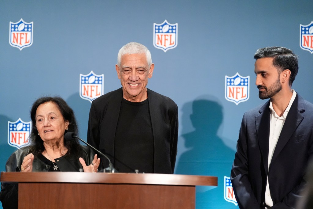 Neeru Khosla, left, Vinod Khosla, center, and Neal Khosla speak during a news conference during an NFL football owners meeting. AP Photo/Brynn Anderson