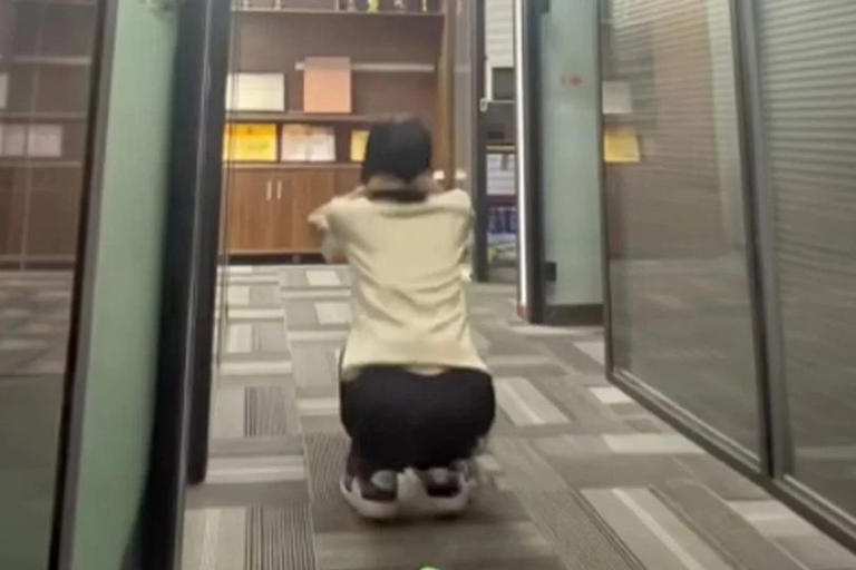 Yang squatting around the office.