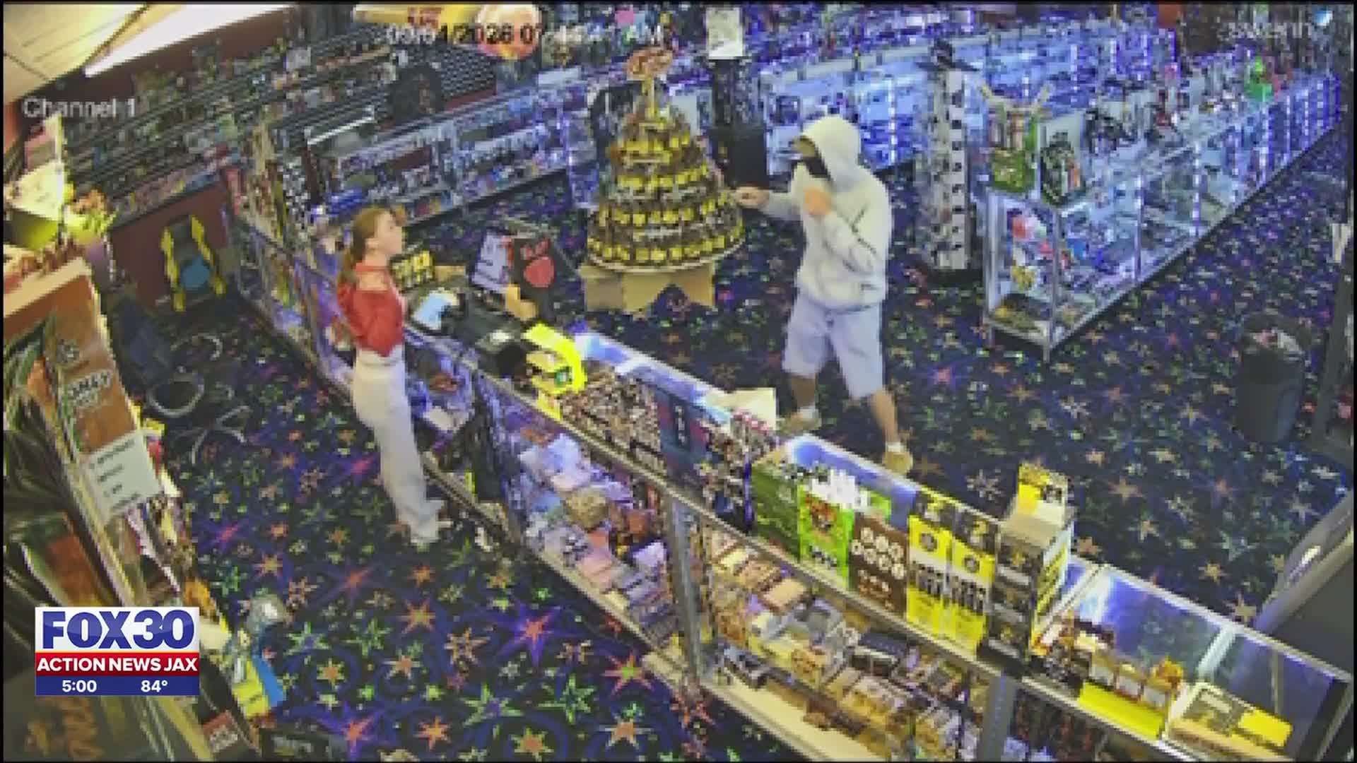 Video shows moment masked robber holds local smoke shop employee at knifepoint