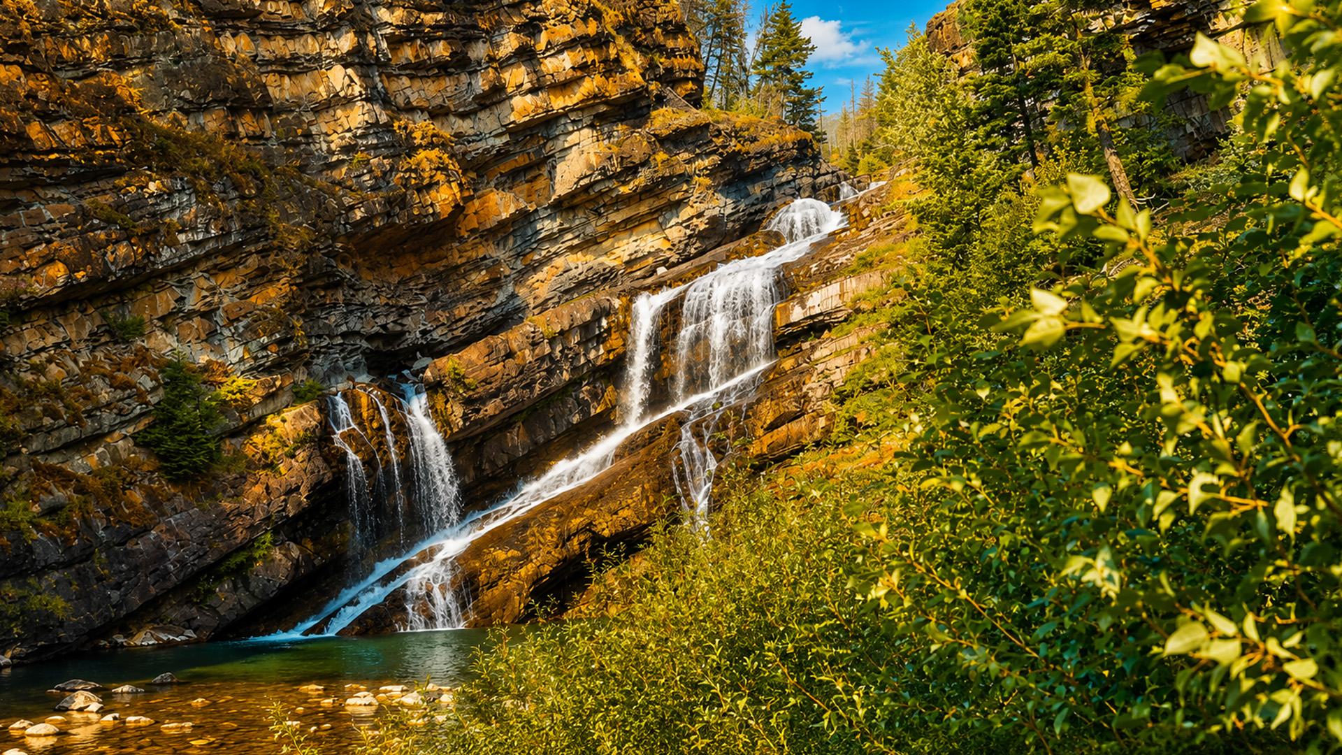 Cameron Falls rushing through Alberta’s rugged rock landscape