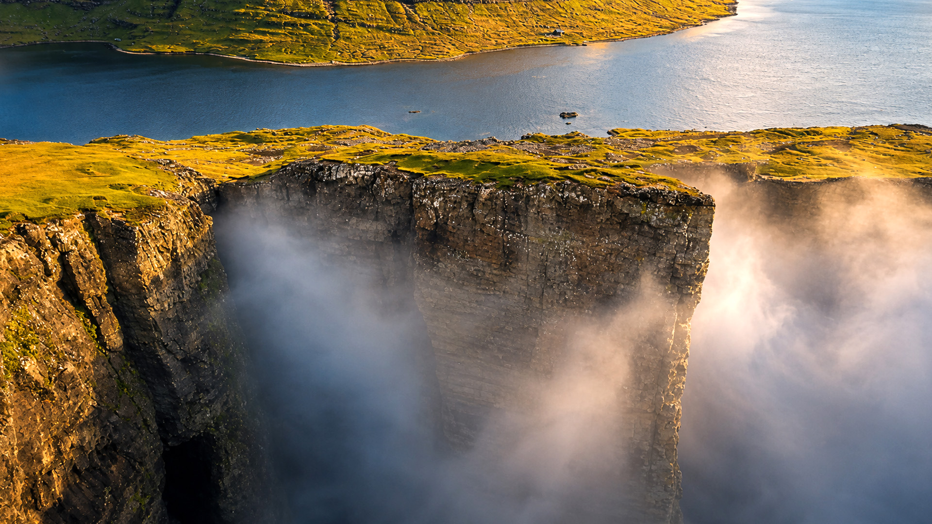 Towering cliffs rising through the mist along Denmark’s coast
