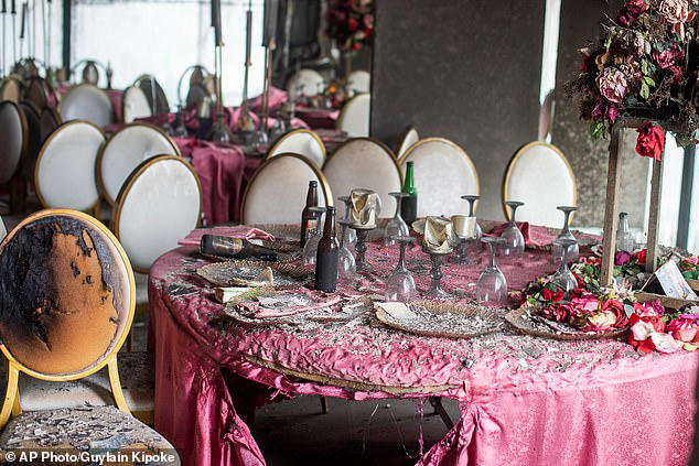 Scorched table clothes and chairs pictured inside the wedding venue in the Democratic Republic of Congo's capital city, Kinshasa