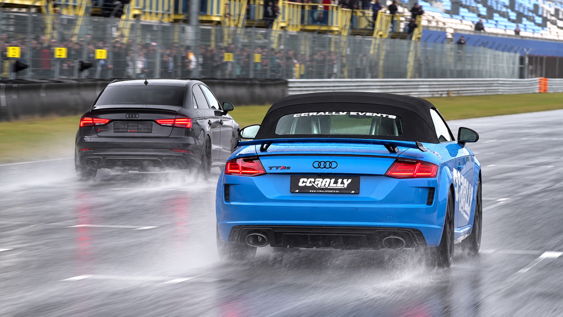 Audi TT RS leads an Audi S4 through standing water