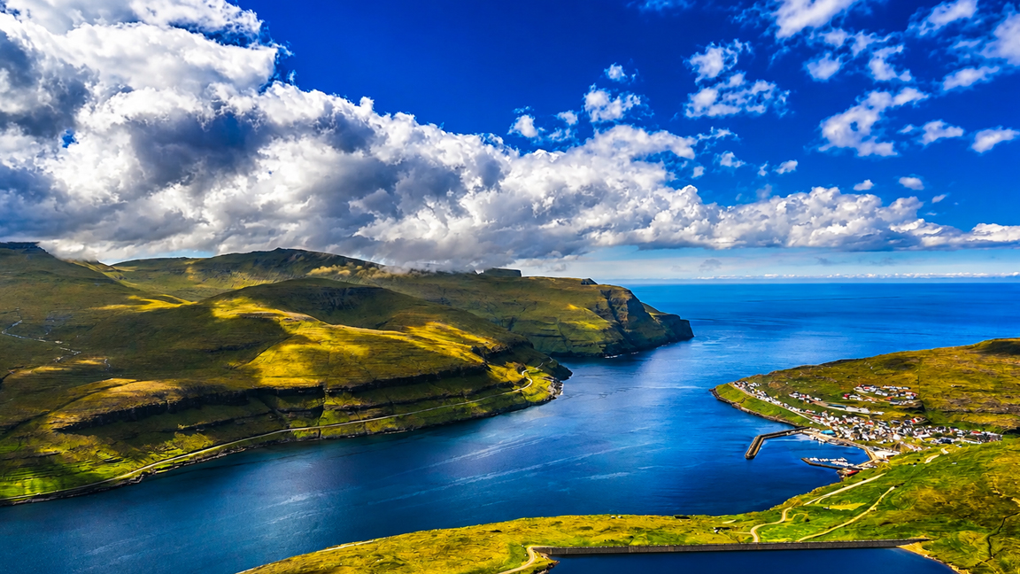 Dramatic Clouds Drift Above A Remote Coastal Village