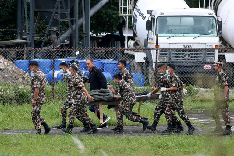 Nepal Army soldiers carry Chandika Shrestha, after she was rescued alive from Betrawati, following devastating floods and mudslides, in Kathmandu, Nepal, September 5, 2026. REUTERS/Dipen Shrestha REFILE - REMOVING VICTIM'S AGE