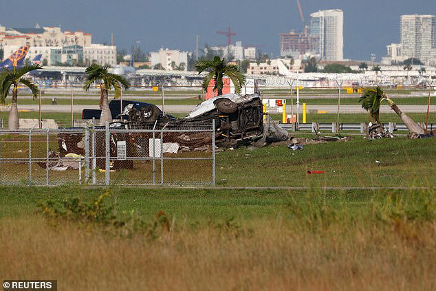 A damaged vehicle is seen in pieces outside Miami International Airport following the crash