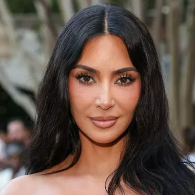 'Tacky': Kim Kardashian pairs a cardigan with a satin skirt at charity auction as fans react to her outfit