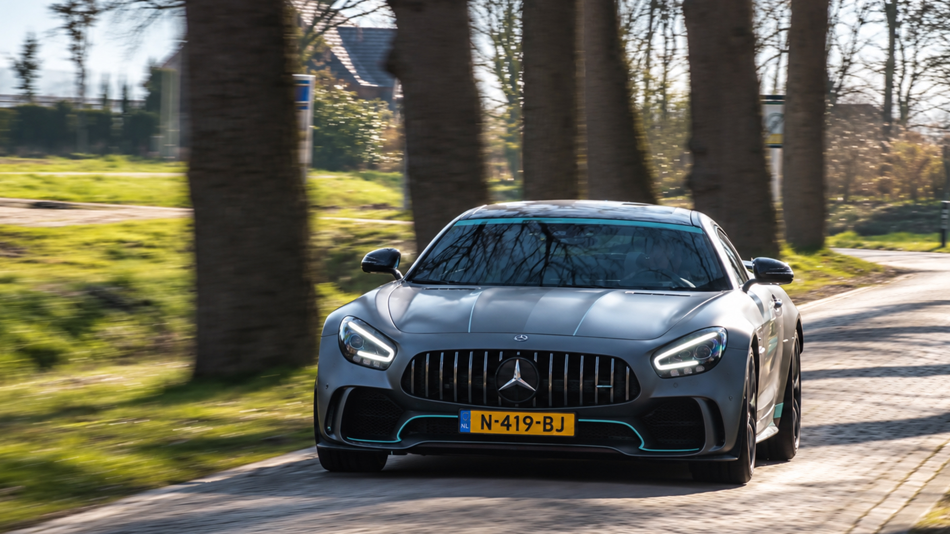 Mercedes-AMG GT R cruises down a tree-lined road
