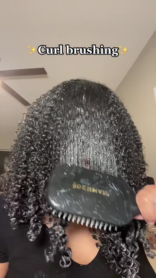 Detangling afro curls before wash day