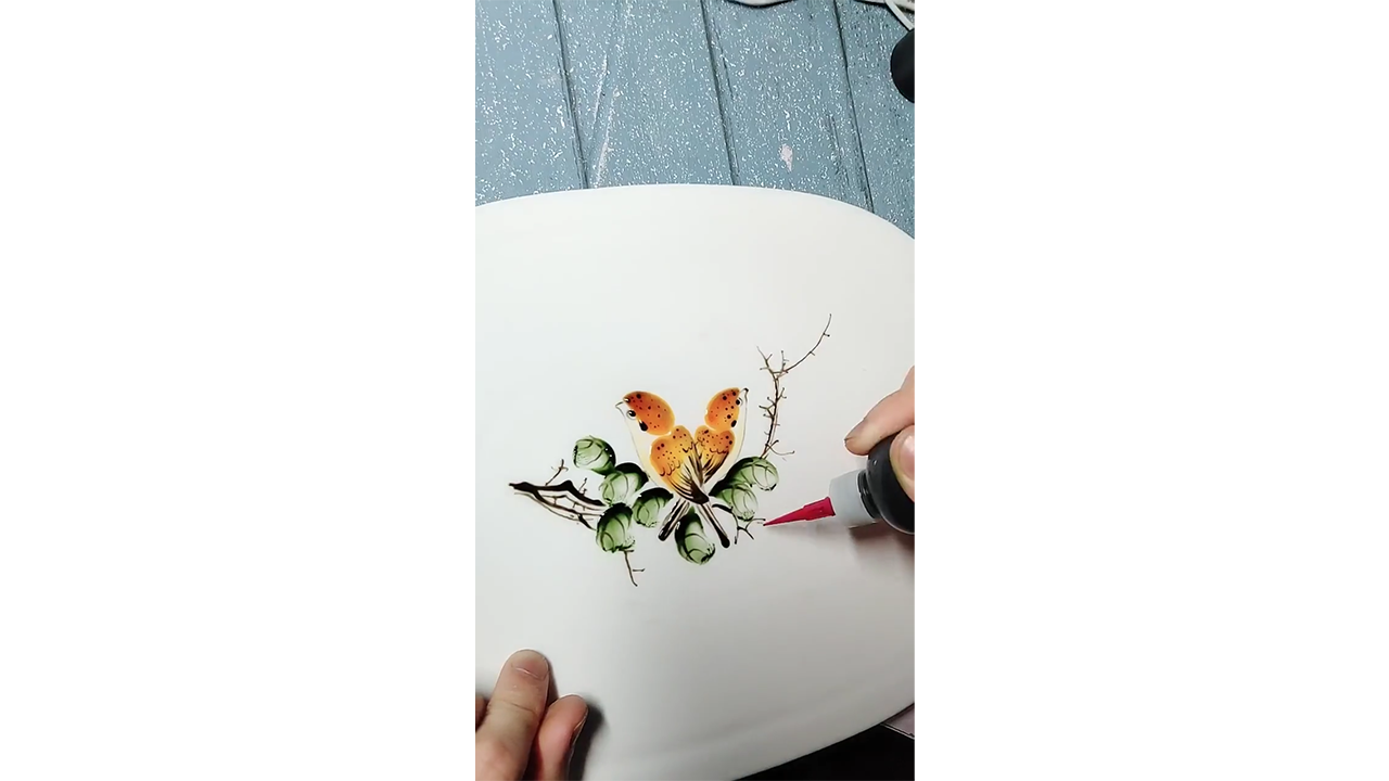 Drawing orange butterfly with colored ink creating elegant nature ...