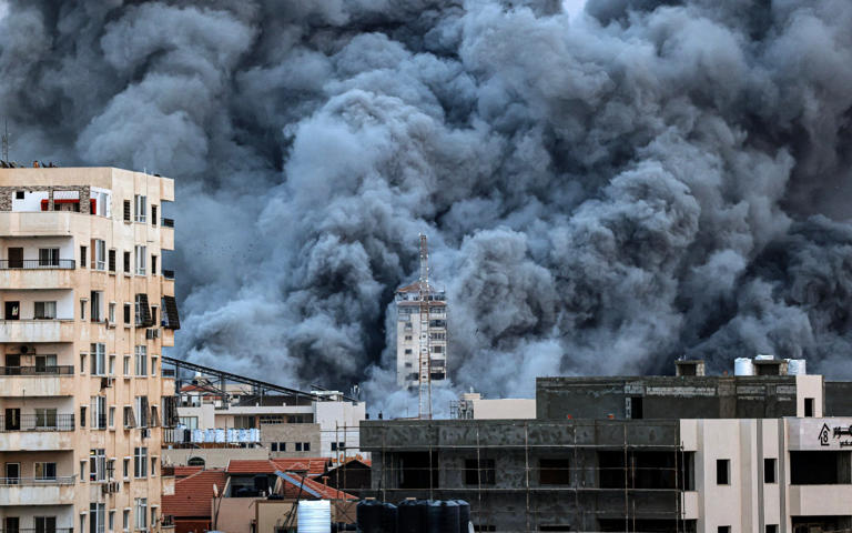Smoke rises above Gaza City on Oct 7, 2023, following an Israeli air strike - AFP/Mahmud Hams