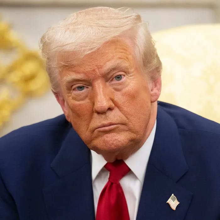A close-up photograph of Donald Trump showing off his noticeably darker, newly dyed hair colour