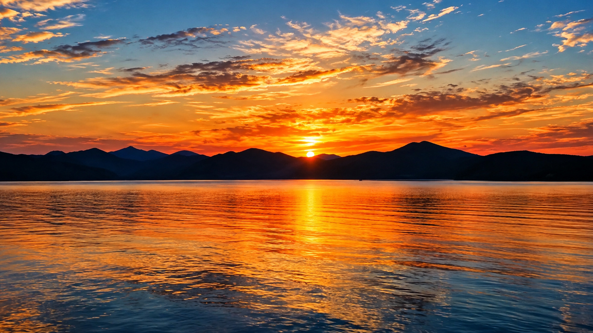 Golden sunset reflections across a peaceful mountain lake
