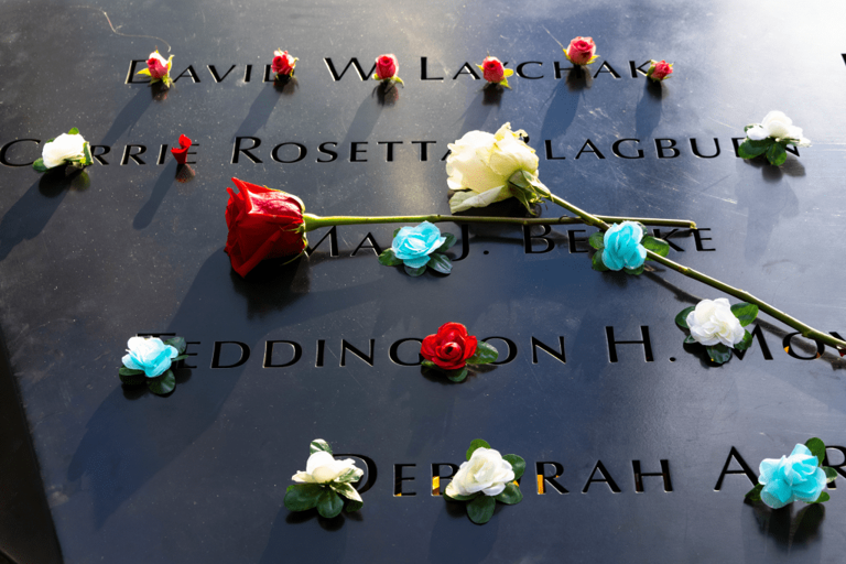 Flowers adorn the names of the victims of the attacks of September 11, 2001, during a ceremony at the National September 11 Memorial & Museum on September 11, 2021, in New York City.