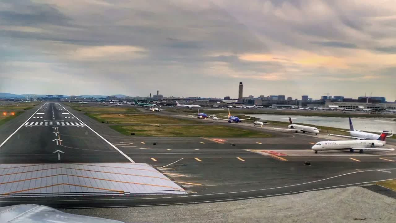 Watch a small aircraft land at busy Boston Logan Airport - 