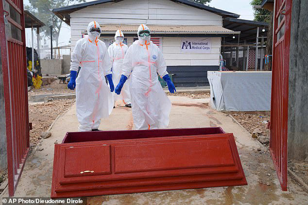 The above shows health workers with the coffin of 38-year-old woman Abineno Justine, who died of Ebola in Bunia, DRC. The image was taken on September 4 this year