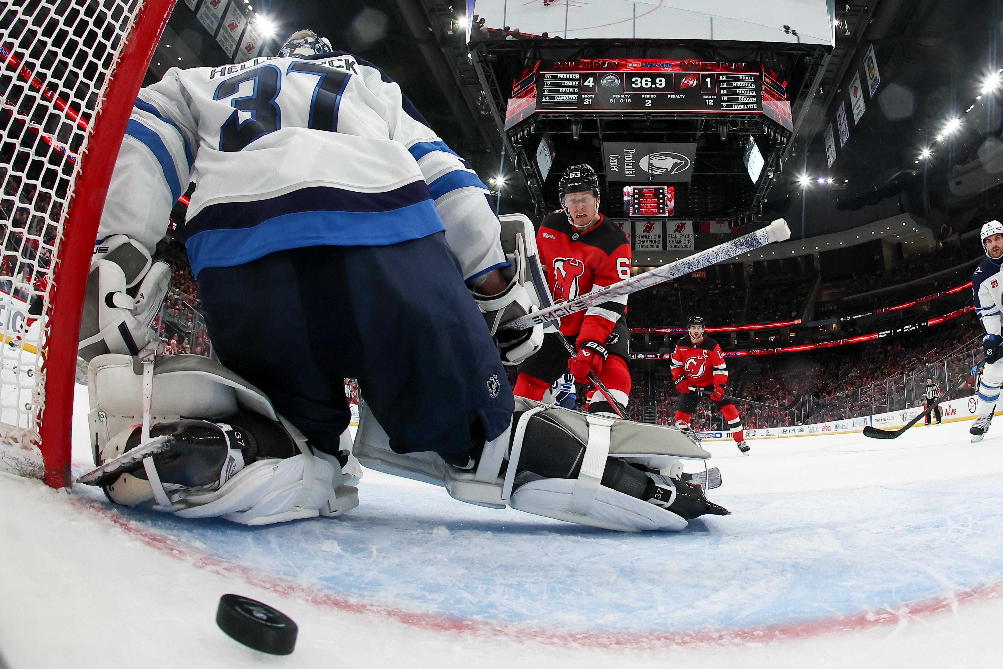 If the New Jersey Devils manage to acquire Quinn Hughes or Connor Hellebuyck, how much does it change the season outlook?